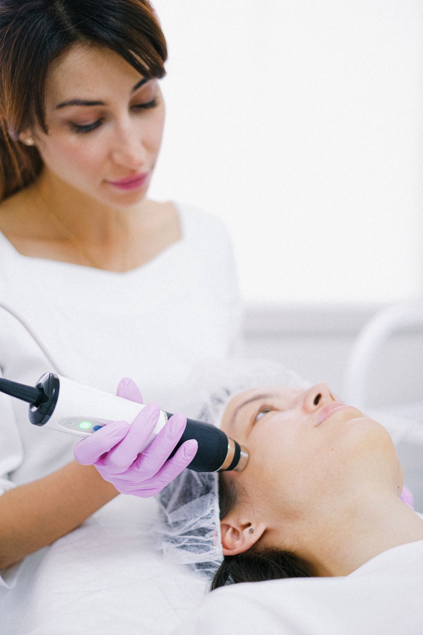 a woman having face treatment